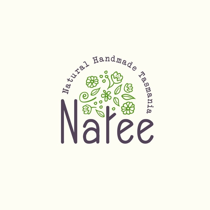 round logo with the letter “t” in “Natee” illustrated as a tree trunk with green leaves and flowers floating above it
