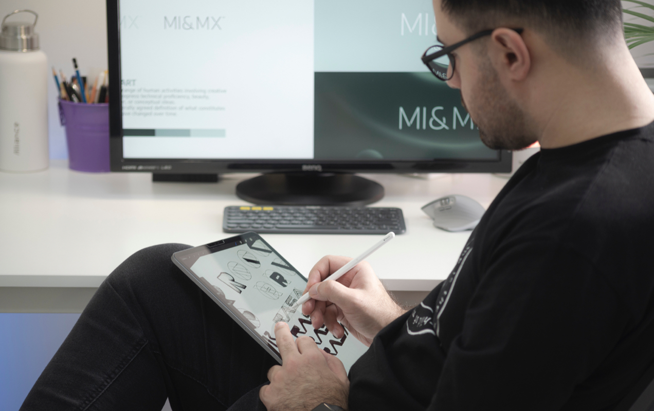 designer drawing logos on a tablet