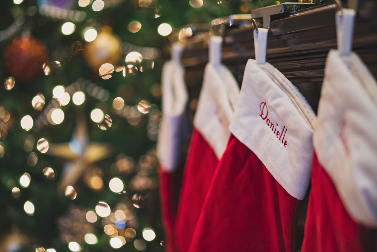 stockings hanging on a mantle by the Christmas tree