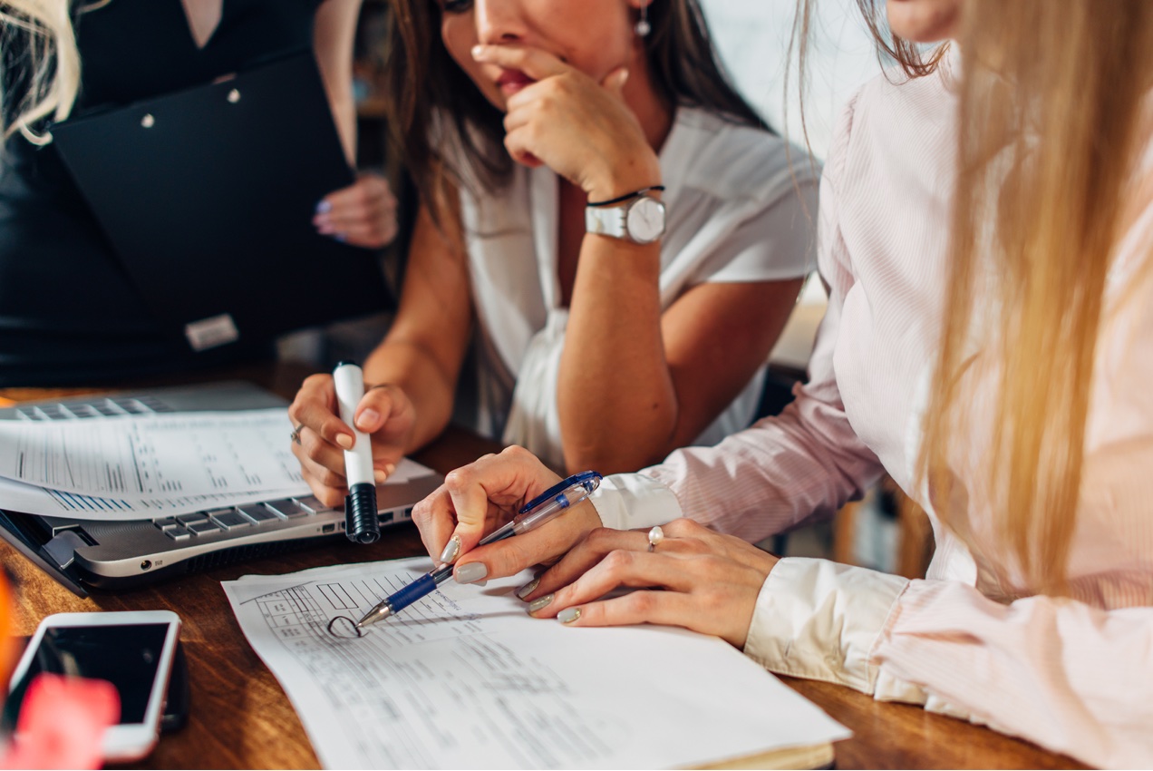 Women discussing business expenses.