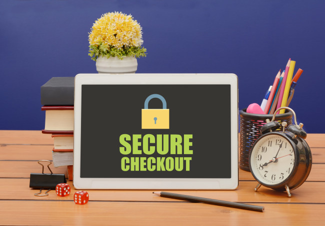 A tablet on a work desk displaying a secure checkout screen.