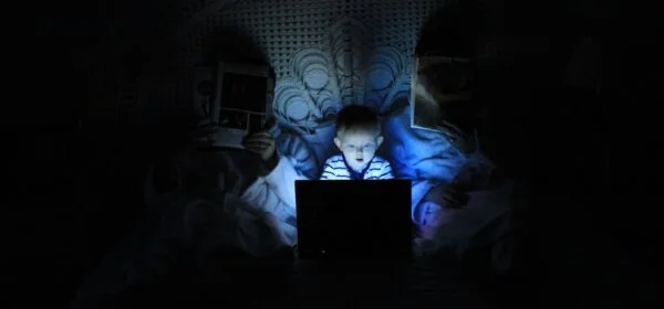 Boy Playing At Laptop Inside Room