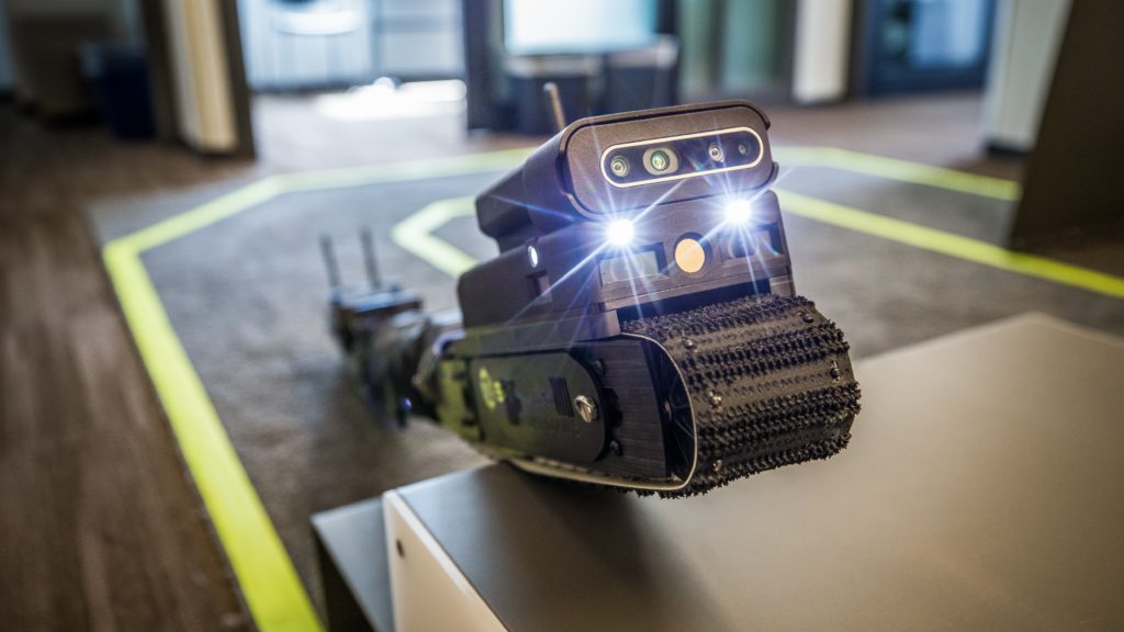 Photo of snake-like robot with two lights on the front